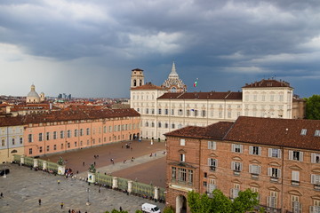 Fototapeta na wymiar Turin, Piedmont, Italy - May 05, 2019: Aerial view from Palazzo Madama tower on Castle Square and Royal Palace with the Cathedral Dome against a cloudy overcast sky