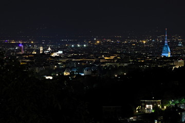 Torino, Italy - October 29, 2019: Panoramic aerial night view on Turin city center with Mole Antonelliana lighted in blue, from Europa Park in Cavoretto