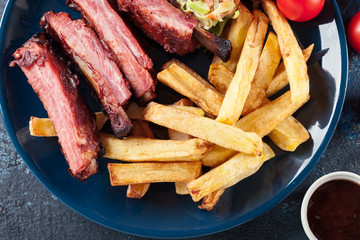 Spicy barbecued pork ribs served with french fries