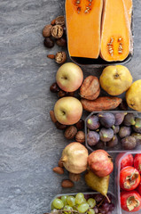 .Top view to fall fruits over a grey  background with copy space.