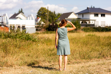 Woman on the meadow in the construction area