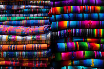 Typical Guatemalan fabrics, stacked colorful handmade fabrics - Antigua Guatemala