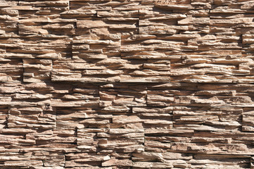 Abstract beige brown slate pattern stone block wall texture for background and wallpaper large and wide modern stone wall facade