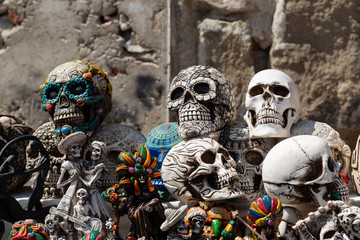 Plakat Ceramic handmade skulls in the stacked market- colorful painted skulls - Día de Muertos