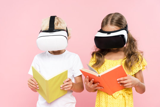 kids with virtual reality headset reading book isolated on pink - Powered by Adobe