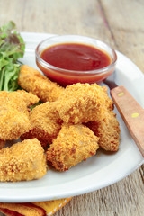 plate of chicken nuggets with ketchup