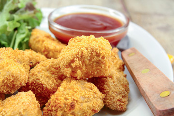 plate of chicken nuggets with ketchup