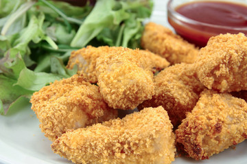 plate of chicken nuggets with ketchup
