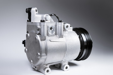 Close-up New car air conditioning compressor on grey background