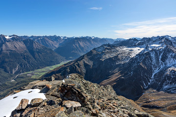 View from the summit of a mountain (Fundusfeiler, Oetztal Alps, Austria) at a clear sunny day in autumn to the Oetztal Valley and Stubai Alps.