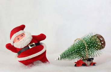 Toy Santa Claus and car carrying Christmas tree in snowy landscape. Space for text.