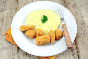plate of chicken nuggets with mashed potatoes