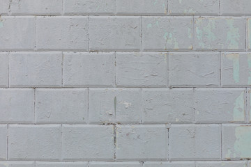 Wall of blue tiles covered with gray paint. Background. Photowall-paper. Copy space.