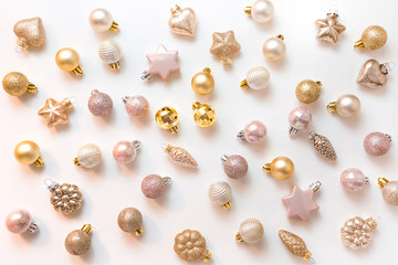 Christmas background with golden and pink glitter balls on white. Top view. Xmas pattern. New Year....