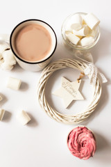 Cup of hot cocoa with marshmallows and christmas tree decorations on a white background. Christmas inspiration.