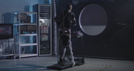 Astronaut exercising in a space station