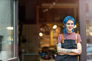 Confident young craftswoman in her workshop