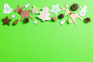 Christmas green background with holiday toys and decorations. Happy New Year concept with empty space for your design