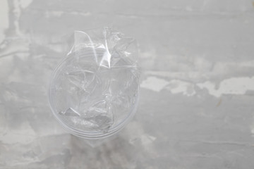 plastic glass with plastic on ceramic background