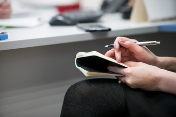 Handwriting, hand  writes with a pen in a notebook