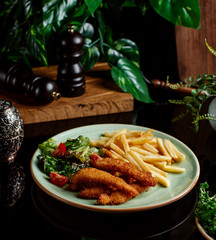 chicken nuggets with fries and vegetables