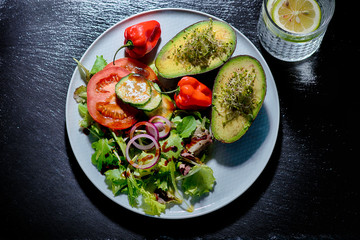  avocado with green salad, tomatoes, snake cucumber, red onions and chillies