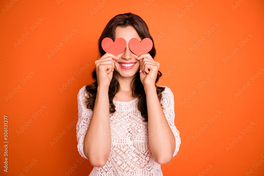 Wall mural portrait of positivce cheerful girl hold red little paper card heart hide her eyes play with boyfrie