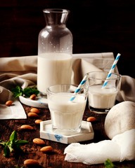 Almond milk on a dark wooden background