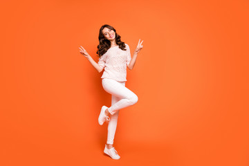 Fototapeta na wymiar Full length photo of charming girl have summer free time make v-sign enjoy holidays wear good looking outfit isolated over orange color background