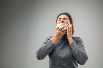 Can't breathe. Caucasian woman wearing the respiratory protection mask against air pollution and dust particles exceed the safety limits. Healthcare, environmental, ecology concept. Allergy, headache.