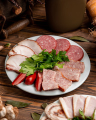 plate with sliced ham and sausages 1