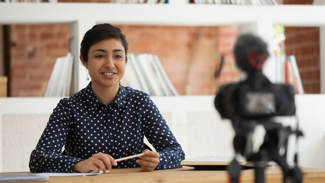 Happy indian girl recording self-introduction or educational video. - Powered by Adobe