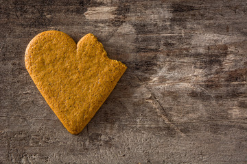 Broken Heart shaped cookie on wooden table. Valentine's Day and Mother's Day concept. Top view. Copy space	