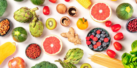 Vegan food panoramic flat lay shot. Healthy diet concept. Fruit and vegetable variety, pasta, nuts, pulses, mushrooms, shot from above on a white background