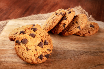 Chocolate chip cookie, gluten free, a close-up on a dark rustic background with a place for text