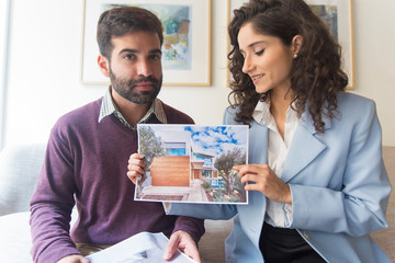 Modern architects presenting project during video webinar. Young man and woman using gadget for video call. Video conference concept