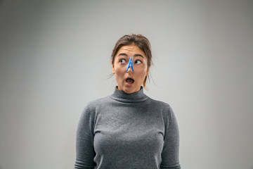 Awful. Caucasian woman wearing the respiratory protection pin clasp against air pollution and dust particles exceed the safety limits. Healthcare, environmental, ecology concept. Allergy, headache.