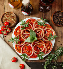 sliced tomato and onion with herbs