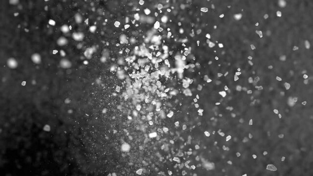 Super Slow Motion Shot of Salt Falling on Black Background at 1000fps. Filmed on High Speed Cinema Camera in 4K Resolution