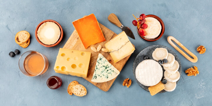Cheese and wine flat lay panorama, a top shot of a cheese board