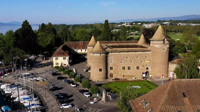 Reverse aerial flying away from Morges Castle at Lake Geneva, Morges, Vaud, Switzerland