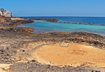  seaside landscape with ocean beach and blue sky on the island of Lanzarote in spain