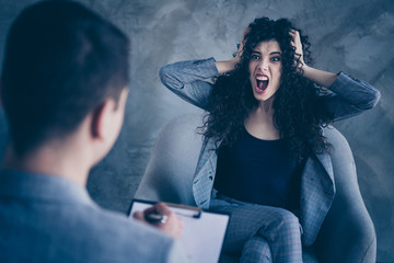 Portrait of her she nice attractive crazy mad emotional outraged irritated wavy-haired girl sitting...