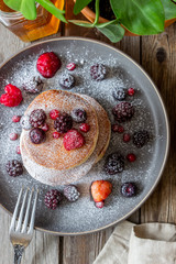 Pancakes with blackberries, raspberries and red currants. American cuisine.