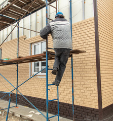 Fototapeta premium Installation of siding on the walls of the house