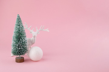 Creative layout made of Christmas decorations on pink background. Holiday background.