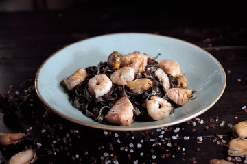 Fototapeta premium Black pasta and seafood mussel shrimp