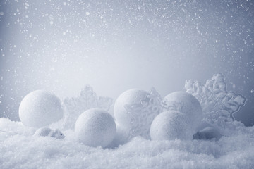 Abstract Christmas background with glass balls on snow background