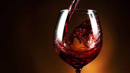 Detail of pouring red wine into glass