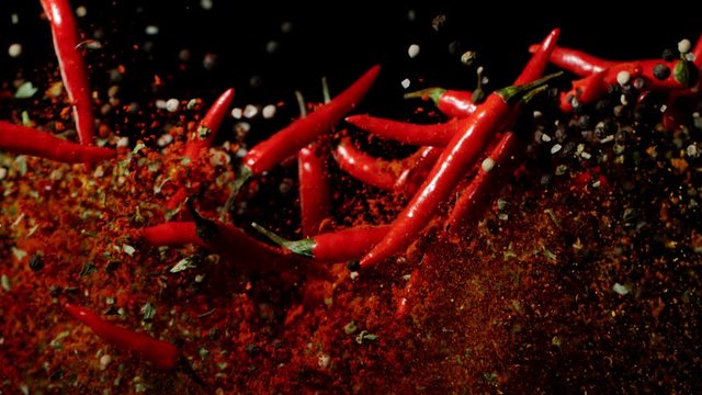 Super slow motion of flying dry and fresh red hot chilli peppers. Filmed on high speed cinema camera, 1000 fps